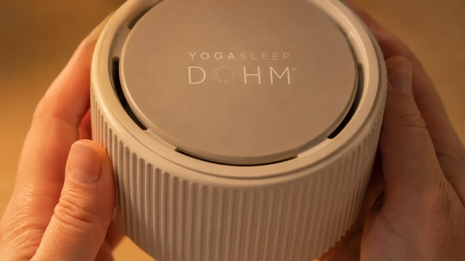 Close-up of the Yogasleep Dohm Classic housing showing the two-part collar and cap dial mechanism